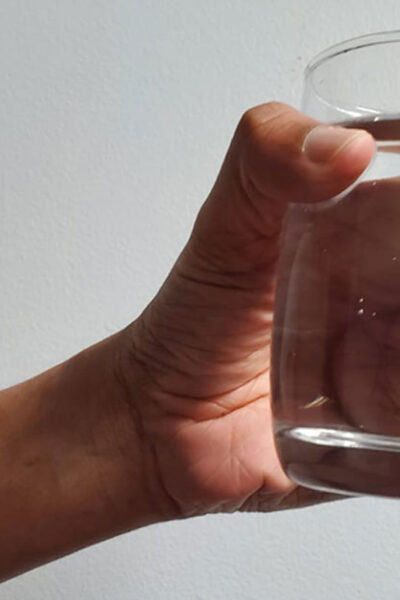 holding glass of water