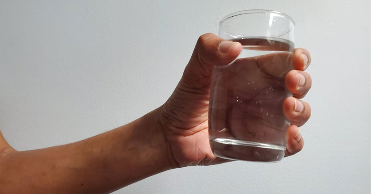 holding glass of water